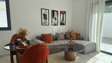 Standard Apartment | Living area | 50-inch Smart TV with satellite channels