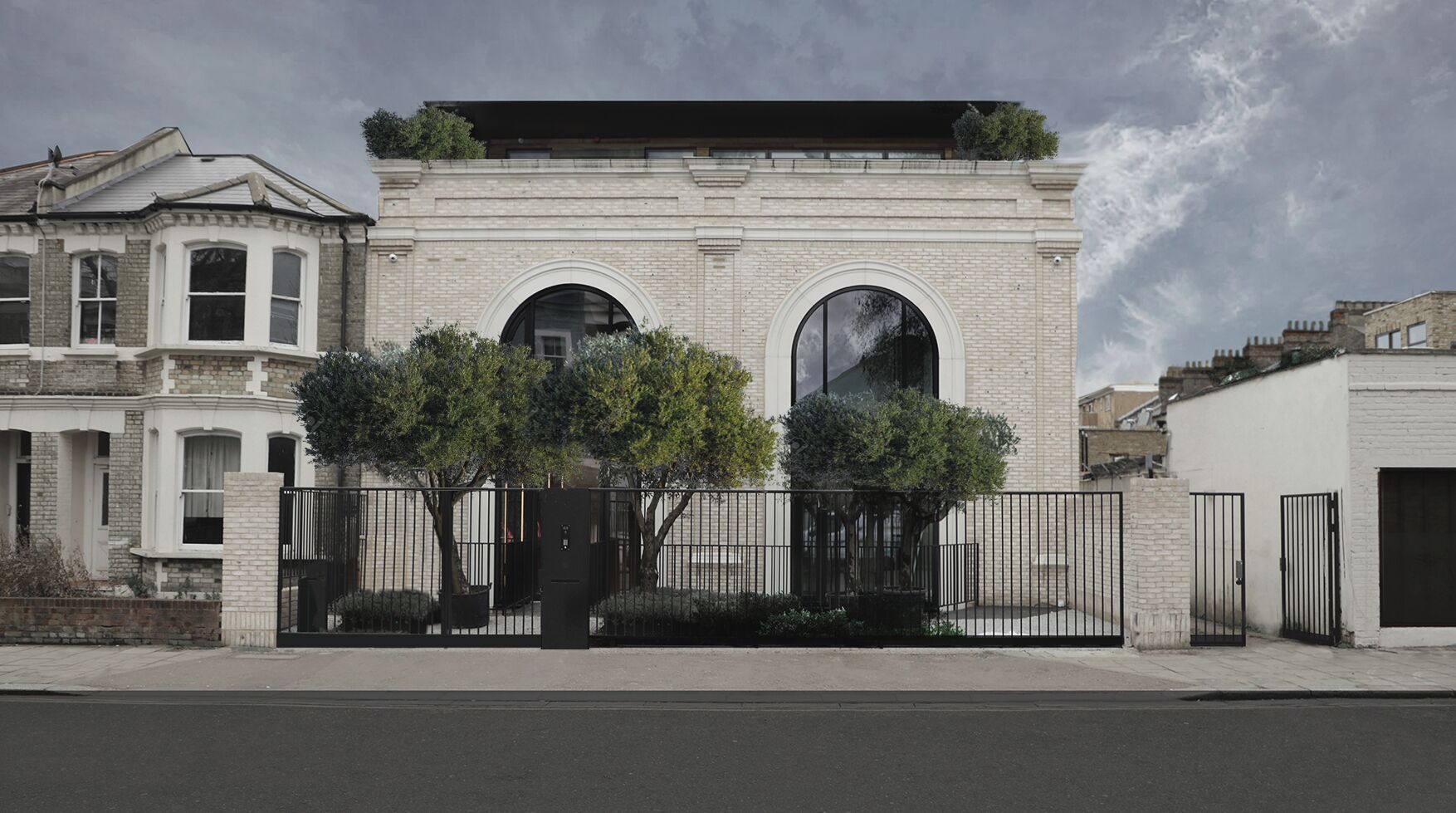 Un edifici modern amb dues grans finestres d'arc i un terrat pla.