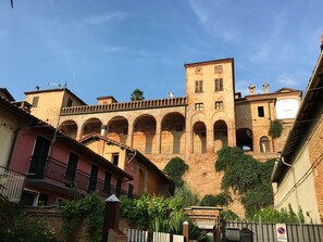 A historic building with arched walkways and a central tower.