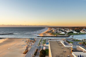 A coastal town with a beach, a marina, and a road leading to a parking area. - Oceanfront Beach Condo, Pool, Gym, Fishing Surfing (Virginia Beach)