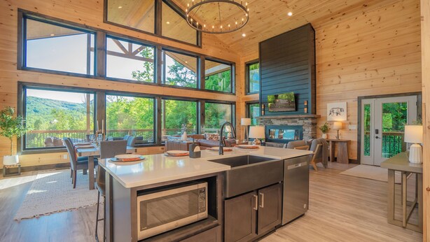 A spacious kitchen with a large island, built-in appliances, and a view of the outdoors.