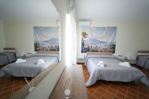 A hotel room with two beds, a wooden table, and a large window. - Don Antonio House Vesuvius (Trecase)