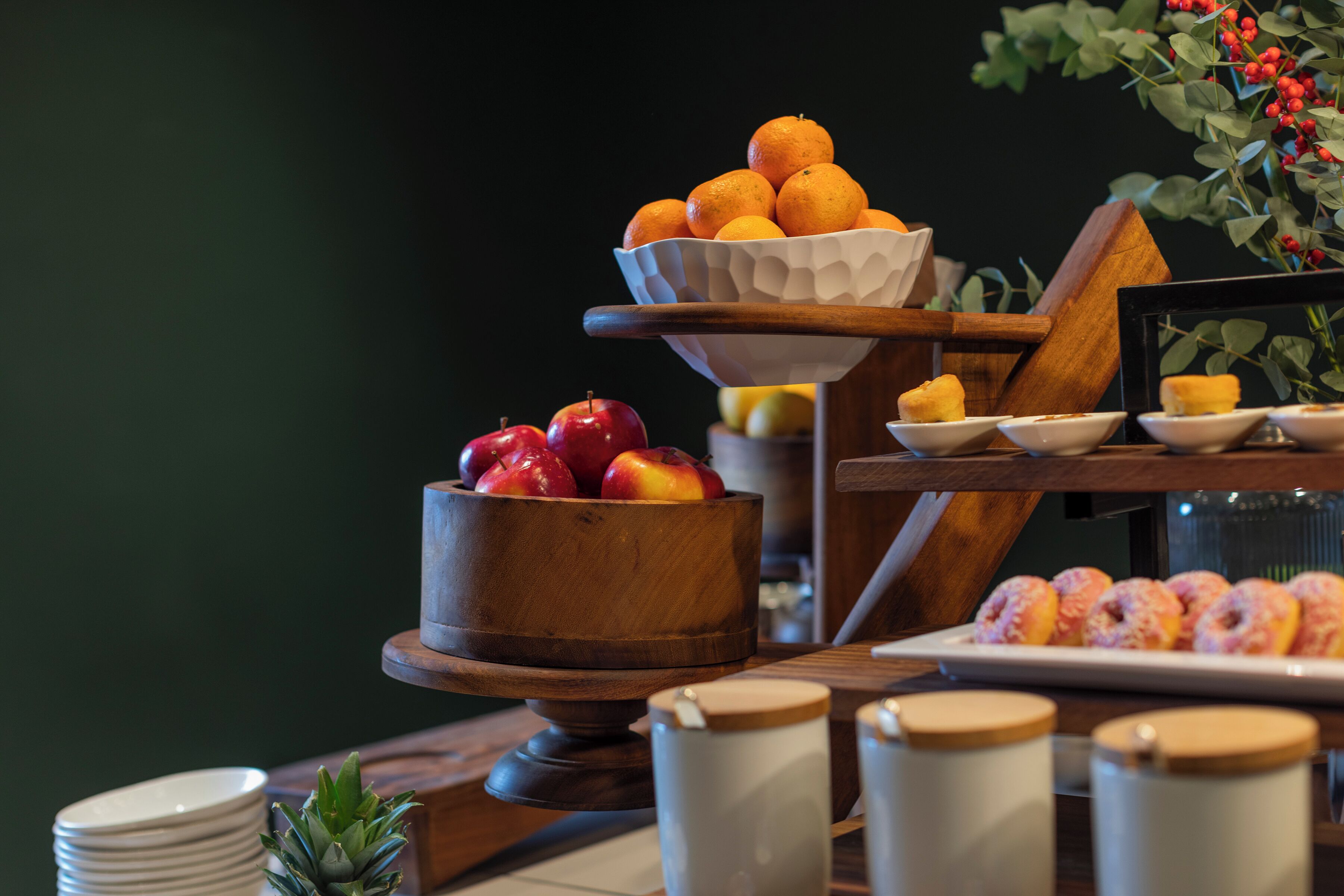 A breakfast buffet with various fruits and pastries.