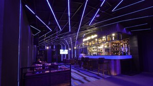 A bar area with a modern design, featuring a bar counter and seating. - Balkrishna Palace (Jaypur)