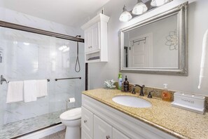 Shower, hair dryer, towels, shampoo
