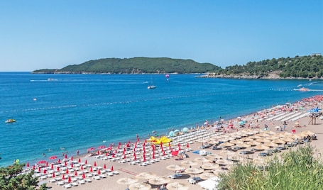 Private beach, white sand, sun loungers, beach umbrellas