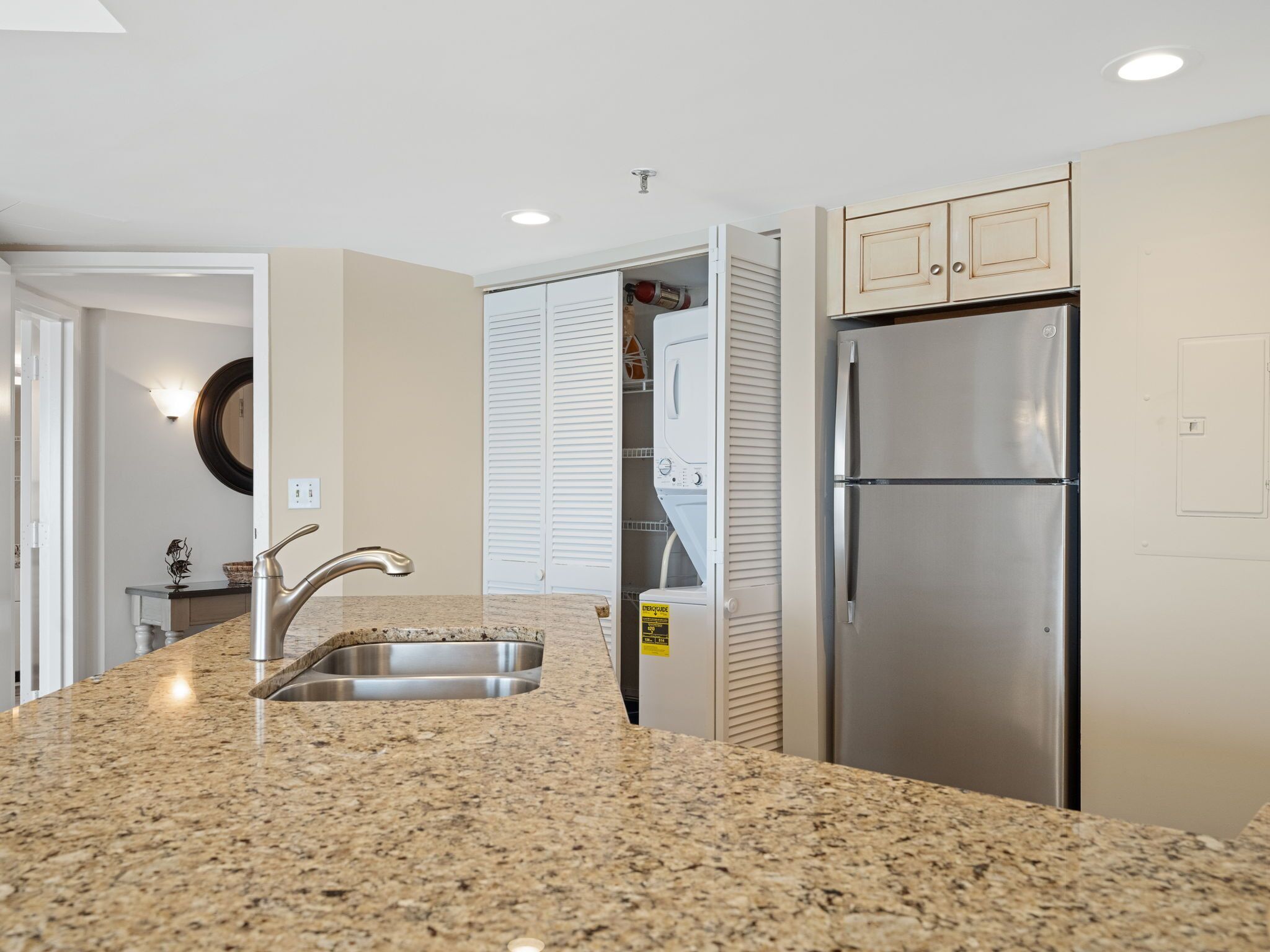 A kitchen with granite countertops, stainless steel appliances, and a built-in oven.