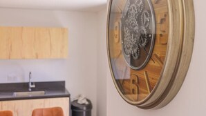 A modern kitchen with wooden cabinets, a black countertop, and a sink. - Apartment Le Cozy, high-end newly constructed! (Montgenèvre)