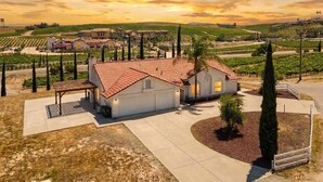 A residential property with a red-tiled roof, a paved driveway, and a landscaped garden. - Private Temecula Getaway | Walk to Wineries (Temecula)