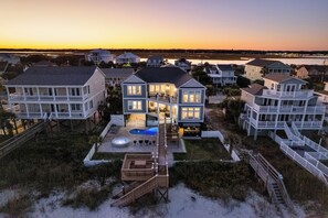 A beachfront property with multiple houses, a swimming pool, and a dock. - Ocean Breeze: Oceanfront Pool & Hot Tub (Murrells Inlet)