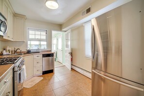 A kitchen with a stainless steel refrigerator, a dishwasher, and a stove.