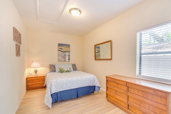 A bedroom with a bed, a nightstand, a dresser, a window with blinds, and wall art. - < 1 Mi to Lake Rousseau: Waterfront Home! (Inglis)
