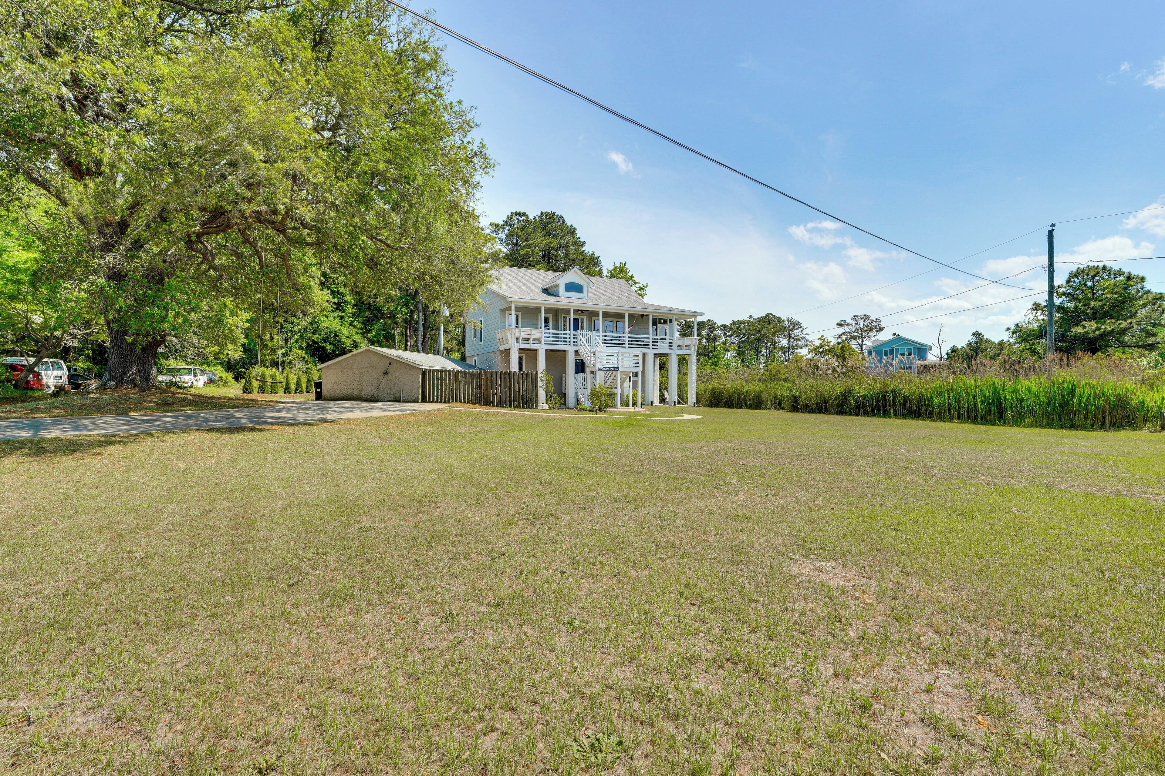 A two-story house with a balcony and a covered porch area.