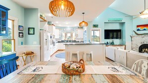 A spacious kitchen with a central island, white cabinetry, and a blue accent wall. - Hot Tub & Bay Views: Outer Banks Home (Kill Devil Hills)