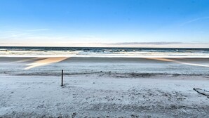 A beach with a clear sky and calm sea.