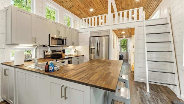 A modern kitchen with white cabinets, stainless steel appliances, and a wooden ceiling. - Secluded Bluebell Cottage with Private Fire Pit! (Menlo)
