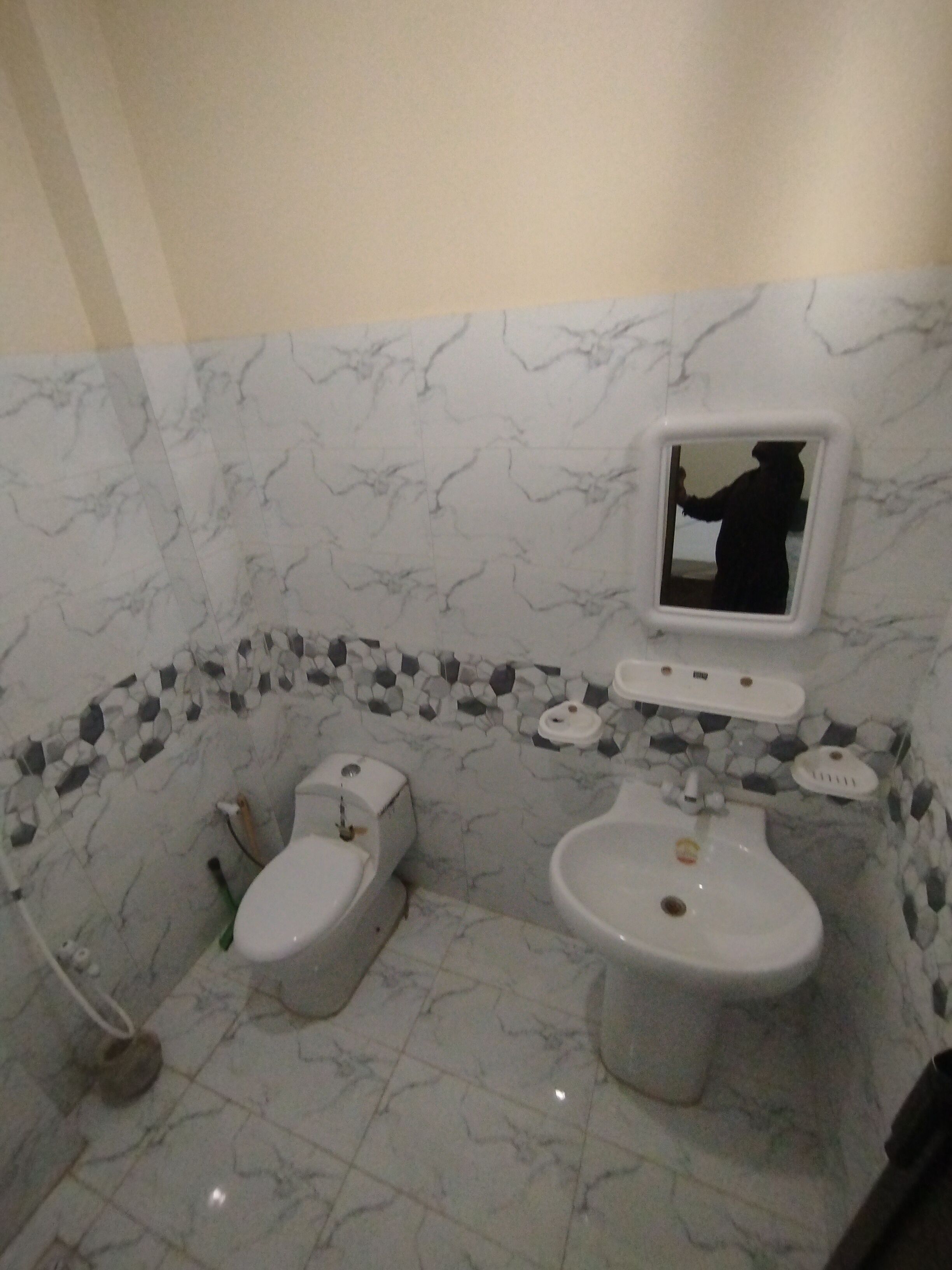 A bathroom with a toilet, bidet, and sink.
