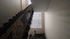 A staircase with ornate black railings and a patterned design. - Hotel Crown Plaza (Karachi)