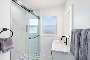 Shower, hair dryer, towels, shampoo