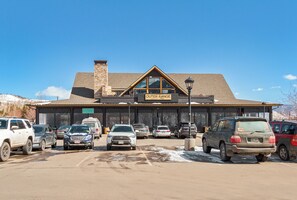 Experience the charm of Outer Range Brewing Co. with its rustic building, complete with a stone chimney and large windows.