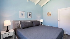 A bedroom with a bed, two bedside tables, and wall art. - Jungle Villa, Pool, Private Patio & Concierge (Playa Potrero)