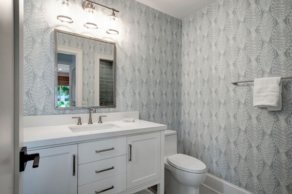 A bathroom with a white vanity, a large mirror, and a toilet. - 10 Turtle Lane at The Sea Pines Resort (Hilton Head Island)