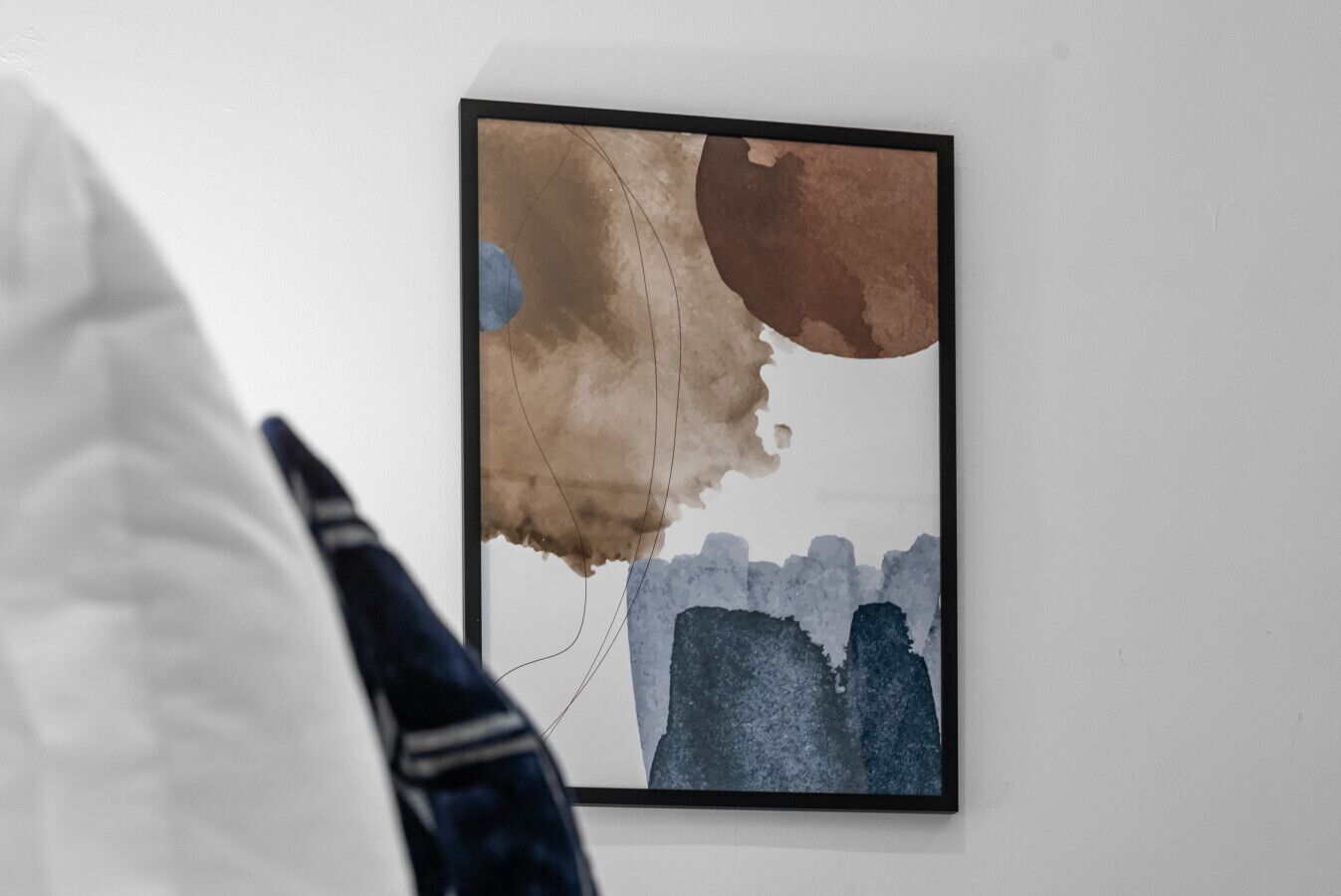 A framed abstract painting on a wall.