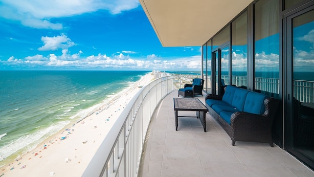 A balcony with a view of a beach and ocean. - Phoenix Gulf Shores Ii 2501 4 Bedroom Condo (Gulf Shores)