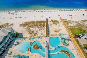 A resort with a large pool area, a beach with umbrellas, and a boardwalk. - Phoenix Gulf Shores Ii 1103 3 Bedroom Condo (Gulf Shores)