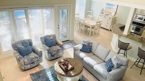 A spacious living area with a gray sofa, floral armchairs, and a coffee table. - 40 Turtle Lane at The Sea Pines Resort (Hilton Head Island)
