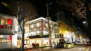 A modern building with a mix of traditional and contemporary architectural styles, featuring large windows and a prominent entrance.