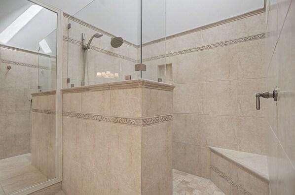 A modern bathroom with a glass shower enclosure, marble tiles, and a built-in bench. - 174 Twin Oaks at The Sea Pines Resort (Hilton Head Island)