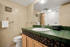 A bathroom with a white sink, a mirror, a towel rack, and a toilet. - 293 Stoney Creek Villa at The Sea Pines Resort (Hilton Head Island)