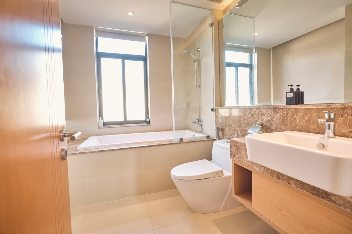 A modern bathroom with a bathtub, toilet, and sink.