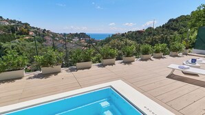A rooftop pool area with a view of the sea and hills. - The Italian Lady - Unit 1 (Alassio)