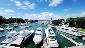 A marina with multiple yachts docked at the pier. - 861 Ketch Court at The Sea Pines Resort (Hilton Head Island)