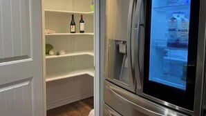 A modern kitchen with a built-in refrigerator and a pantry. - Play & Relax — 4 Kings, Pool Table & 5 TVs Near JW Marriott TPC (San Antonio)
