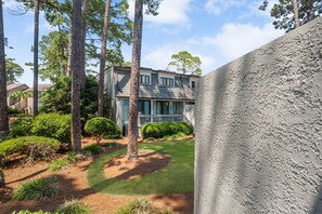 A modern two-story house with a well-maintained lawn and tall pine trees. - 1261 Harbour Town Club at The Sea Pines Resort (Hilton Head Island)