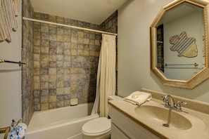 A bathroom with a bathtub, toilet, and sink. - 1033 Caravel Court at The Sea Pines Resort (Hilton Head Island)