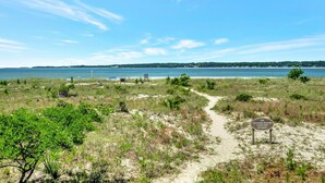 A coastal path leading to a beach with a sign indicating ecological reasons to keep off dunes. - 1829 Beachside Tennis at The Sea Pines Resort (Hilton Head Island)