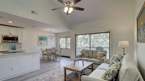 A spacious living area with a dining table, sofa, and a ceiling fan. - 2338 Racquet Club at The Sea Pines Resort (Hilton Head Island)