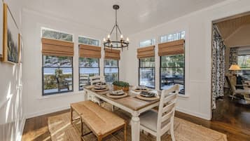 Enjoy meals in this elegant dining area with a wooden table and comfortable seating for four.