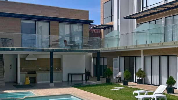 A modern two-story house with a swimming pool, outdoor seating, and a balcony. - Chipipe House, Salinas (Salinas)