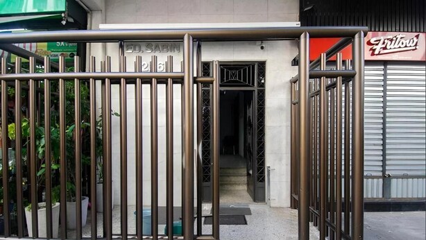 A gated entrance to a building with a sign reading "ED SABIN".