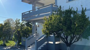 A modern two-story house with a balcony, a staircase, and a tree in the front yard. - Elodi’s Villa (Fushkruje)