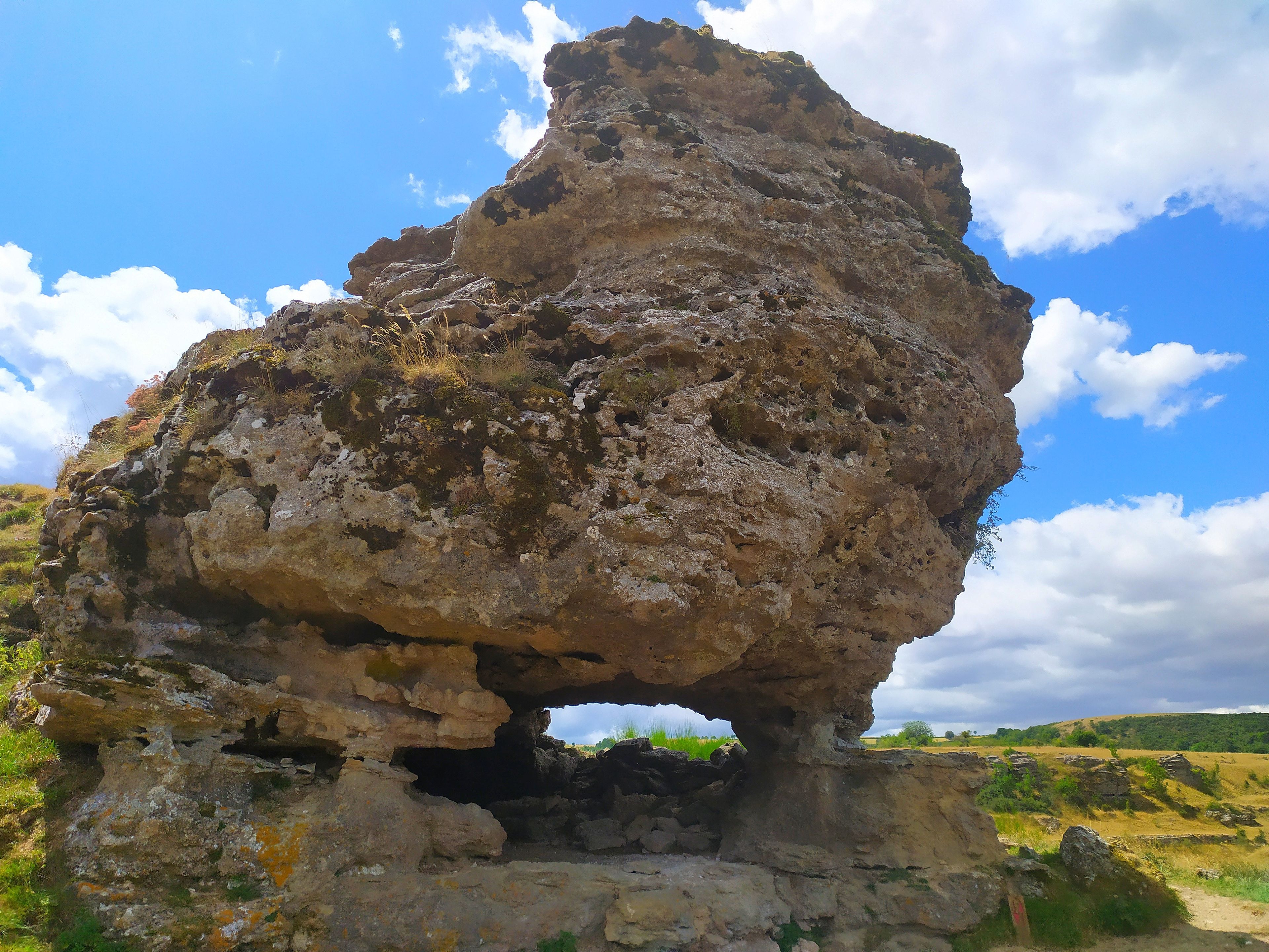 A natural rock formation with a cave-like opening.