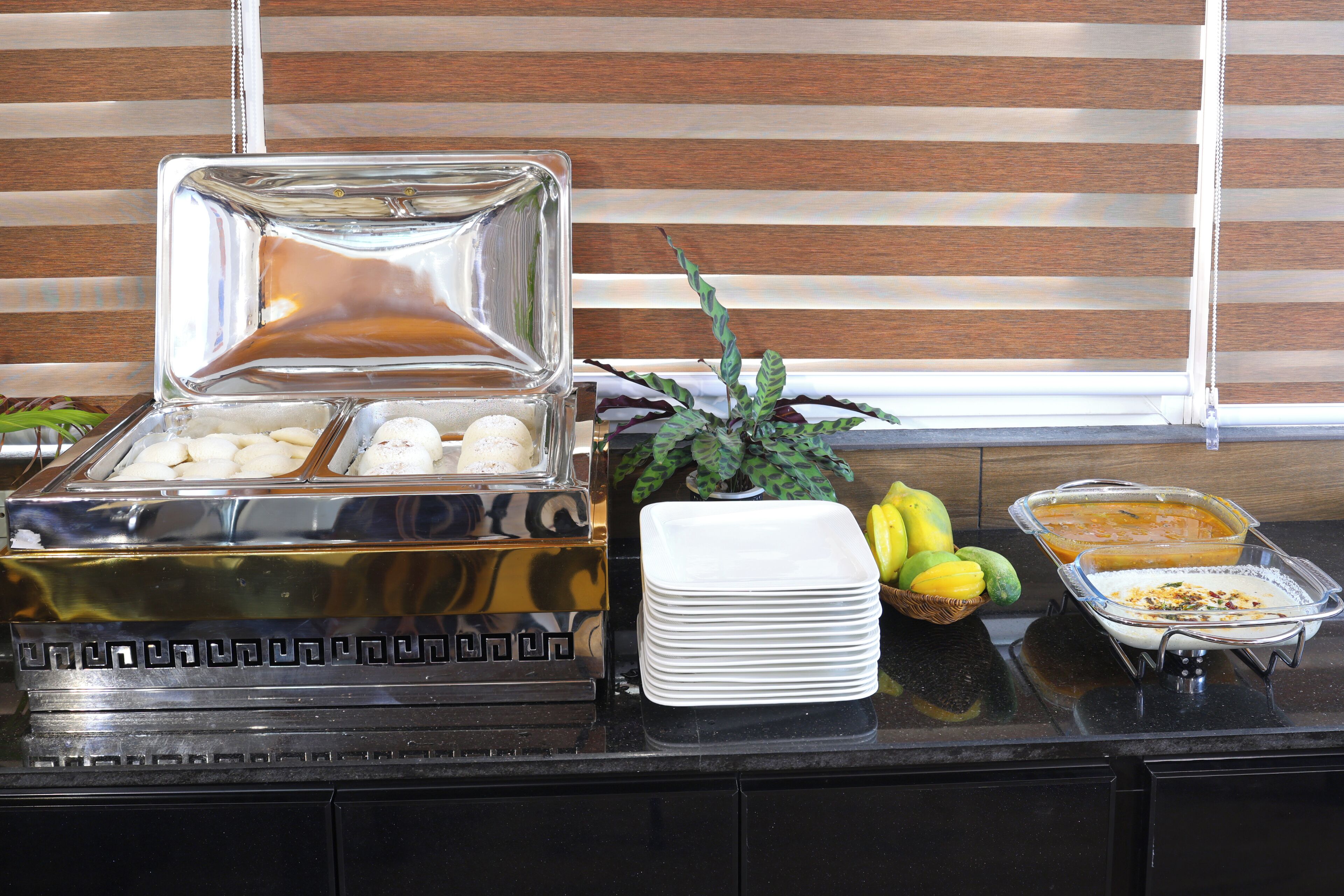 A buffet setup with a variety of food items and serving dishes.