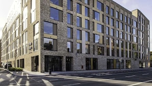 A modern multi-story building with a brick facade and large windows. - Cork Street in Dublin (Dublin)