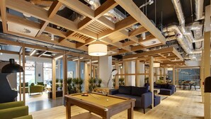 A modern indoor space with a pool table, sofas, and a wooden ceiling structure. - Cork Street in Dublin (Dublin)