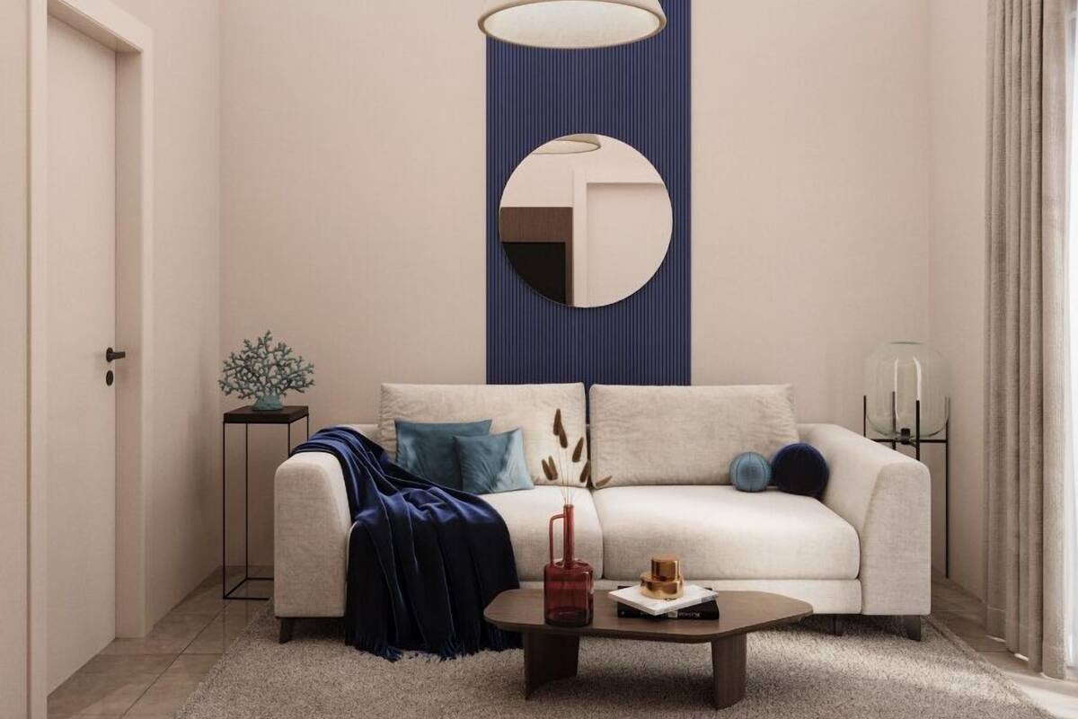 A modern living room with a sofa, coffee table, and decorative items.